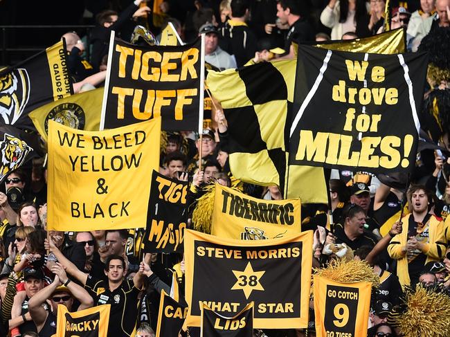 Richmond Tigers cheer squad and fans are seen reacting during the game against the Collingwood Magpies during round 21 of the AFL at the MCG in Melbourne, Saturday, August 22, 2015. (AAP Image/Julian Smith) NO ARCHIVING, EDITORIAL USE ONLY