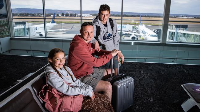 Angus Armstrong with kids Marli, 10, and Lucas, 13, from London after arriving in Adelaide from Canberra on an Alliance plane to holiday on the Yorke Peninsula. Picture: Tom Huntley