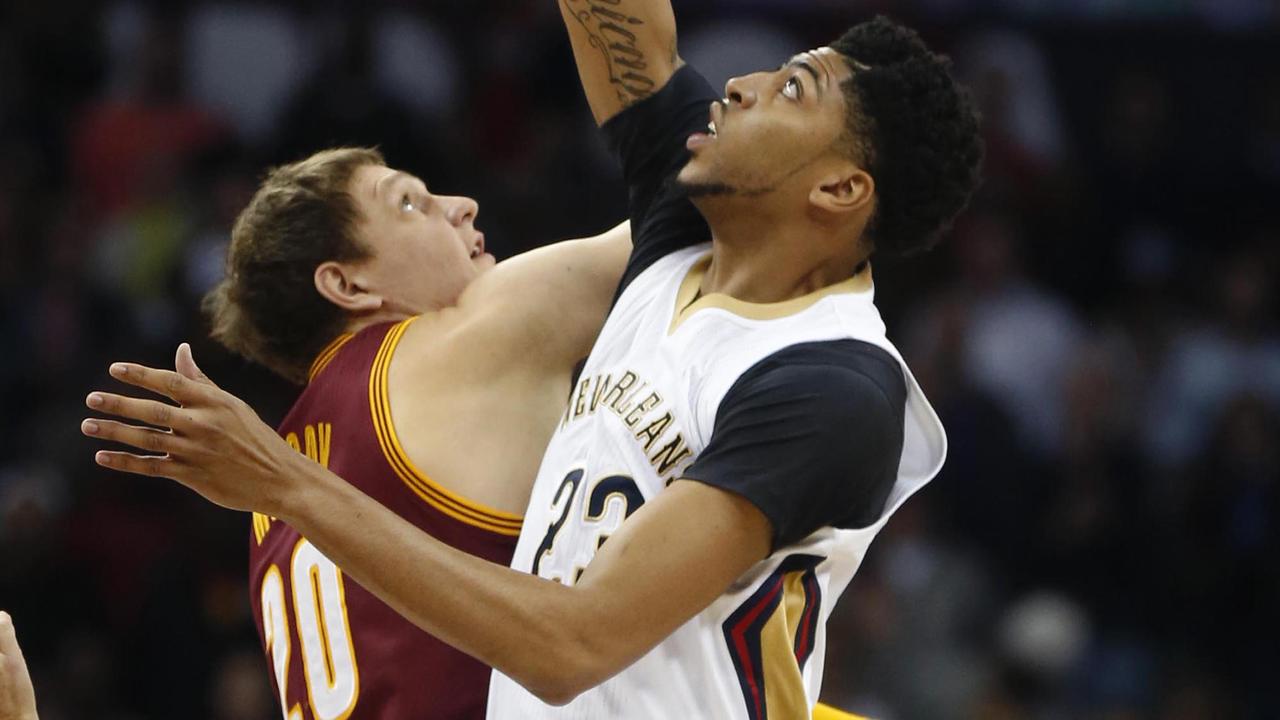 New Orleans Pelicans forward Anthony Davis (23) leaps for the opening tipoff against Cleveland Cavaliers center Timofey Mozgov (20) in the first half of an NBA basketball game in New Orleans, Friday, Dec. 4, 2015. (AP Photo/Gerald Herbert)