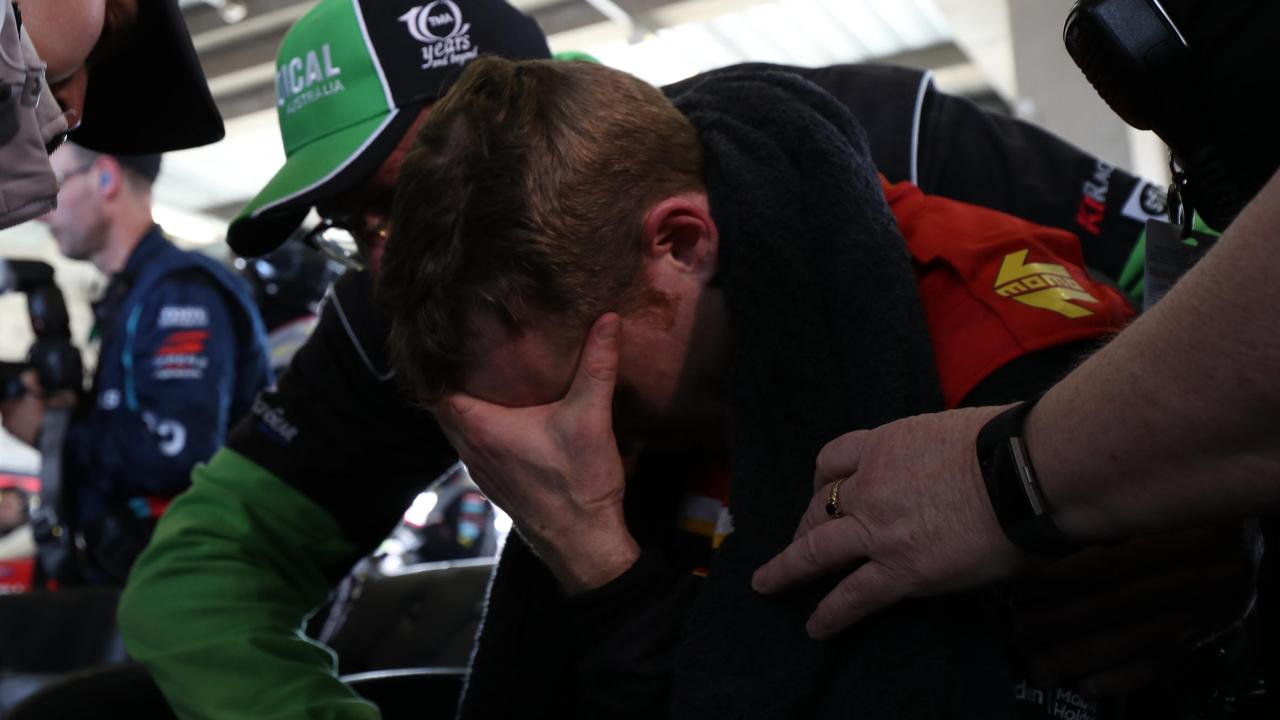 David Reynolds hops out of the car after suffering leg cramps late in the Bathurst 1000.