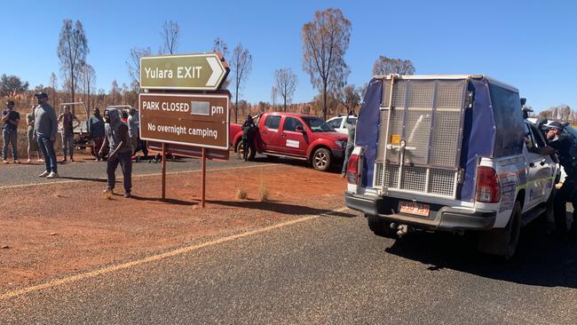 Locals have blockaded the entrance to Uluru-Kata Tjuta National Park in protest against Parks Australia for refusing to close the park.