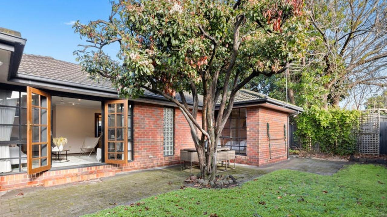 French doors with retractable fly screens open to the garden.