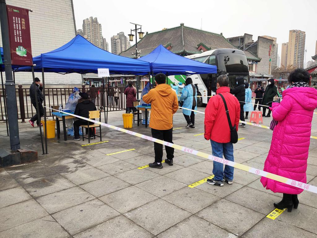 Residents queue to get a swab sample for coronavirus in Tianjin, in northern China. Picture: AFP