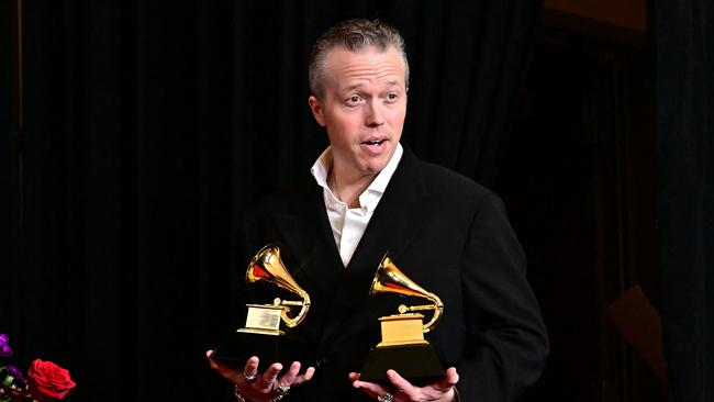 US singer Jason Isbell earlier this week poses in the press room with the Grammys for "Best Americana Roots Song" award for "Cast Iron Skillet" and "Best Americana Album" for "Weathervanes" during the 66th Annual Grammy Awards in Los Angeles. Picture: AAP