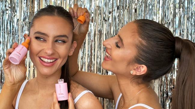 Twin sisters Victoria and Jacqui Hondrou with their tanning products. Picture: Supplied