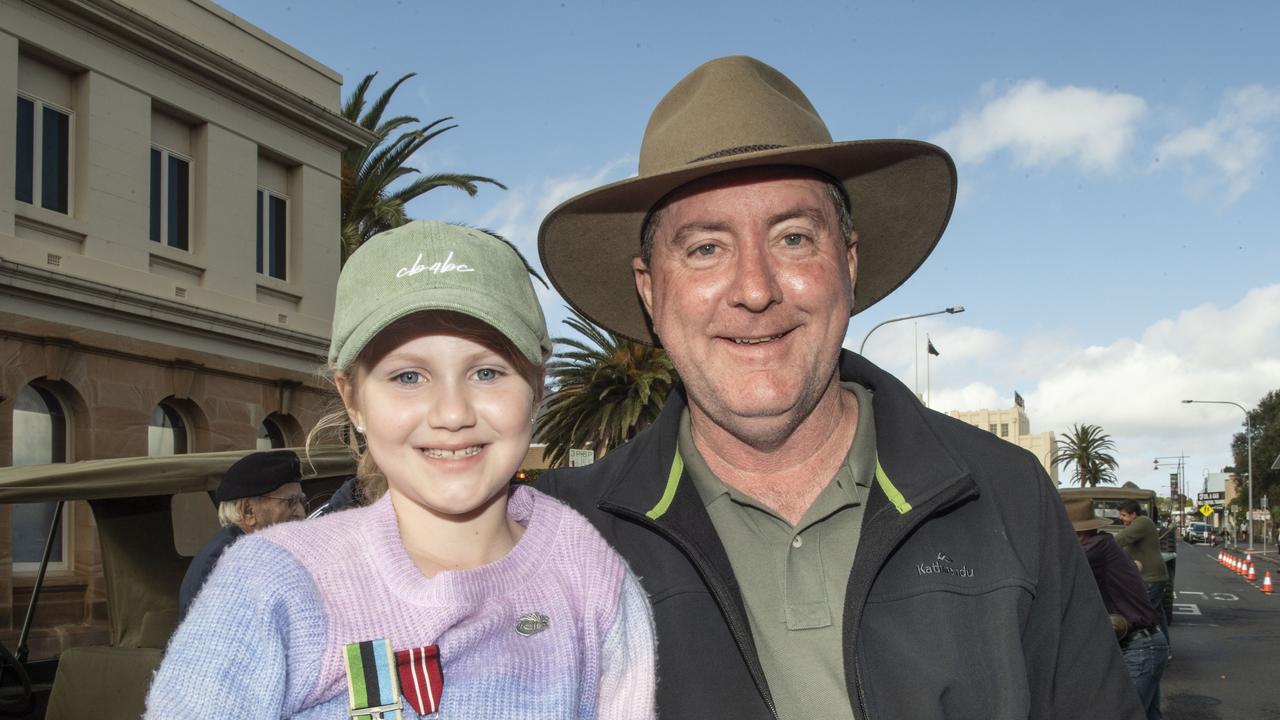 (from left) Peyton Locke and her father Bruce Locke with replacement medals for his father Keith Locke. Assembly in Neil St for the mid morning parade on ANZAC DAY. Tuesday, April 25, 2023. Picture: Nev Madsen.