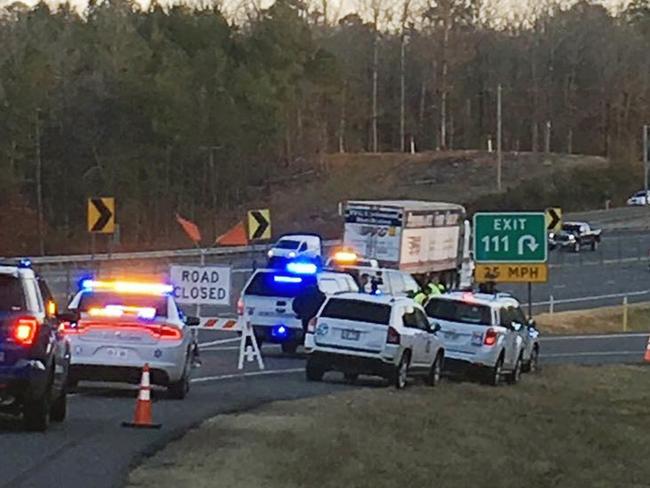 Emergency vehicles are parked along Interstate 30 near the scene where a charter bus that was carrying a youth football team from Tennessee crashed early Monday, Dec. 3, 2018, near Benton, Ark. The bus was carrying the team from Texas to Memphis, Tenn. (Josh Snyder/The Arkansas Democrat-Gazette via AP)