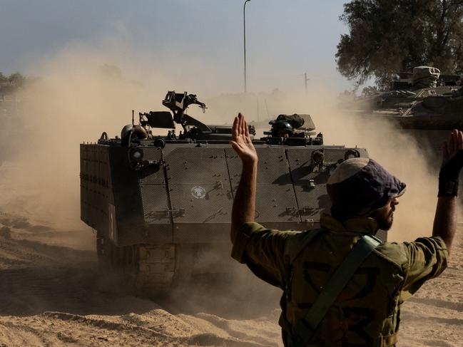 An IDF soldier guides an armoured personnel carrier in southern Israel. Picture: Getty Images