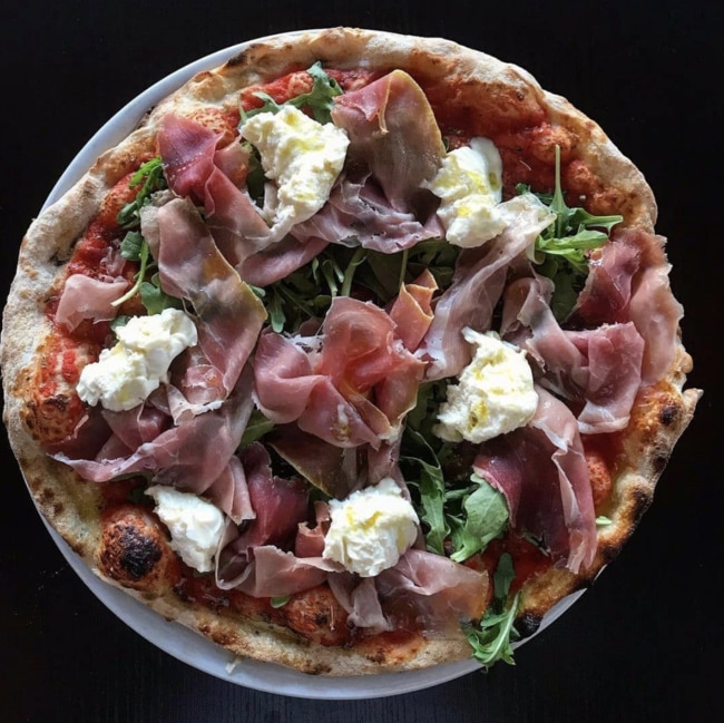 La Lupa’s Califfo pizza is full of tomato, eggplant, prosciutto di Parma, rocket and buffalo mozzarella. Picture: Instagram @laluparestaurant