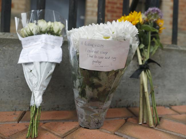 Floral tributes left by the Abbey gateway of Forbury Gardens a day after a multiple stabbing attack in the gardens in Reading, England. Picture: Alastair Grant/AP