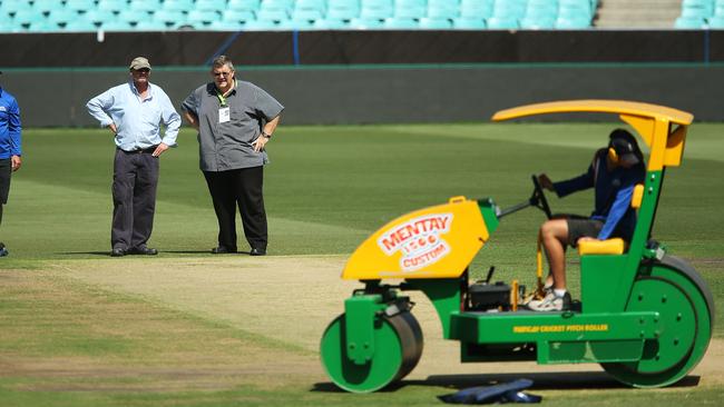 Head groudsman Tom Parker with Andy Atkinson from ICC check the pitch at the SCG ahead of World Cup Semi Final between Australia and India. pic. Phil Hillyard