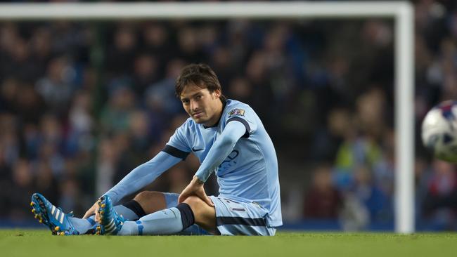 Manchester City's David Silva sits on the pitch after being injured.