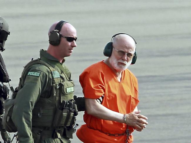 FILE - In this June 30, 2011 file photo, James "Whitey" Bulger, right, is escorted from a U.S. Coast Guard helicopter to a waiting vehicle at an airport in Plymouth, Mass., after attending hearings in federal court in Boston. Officials with the Federal Bureau of Prisons said Bulger died Tuesday, Oct. 30, 2018, in a West Virginia prison after being sentenced in 2013 in Boston to spend the rest of his life in prison. (Stuart Cahill/The Boston Herald via AP, File)