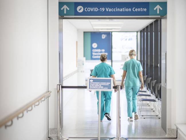 Nurses are seen walking into the COVID-19 vaccination centre at Gold Coast University Hospital. Picture: Getty Images