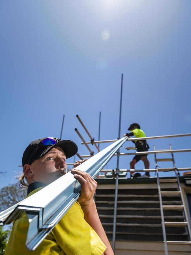 Colonial Roofs apprentice roof plumber Matthew Ostrofski (left) and owner Chris Heron at work in Newtown on a hot spring day. Picture: Kevin Farmer