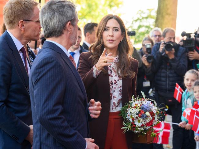 Mary wore burnt orange tailored trousers, a burgundy blazer, and a $340 floral blouse by ME+EM. Picture: Getty Images