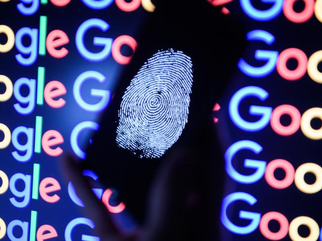 LONDON, ENGLAND - AUGUST 09:  In this photo illustration,  A thumbprint is displayed on a mobile phone while the Google logo is displayed on a computer monitor on August 09, 2017 in London, England. Founded in 1995 by Sergey Brin and Larry Page, Google now makes hundreds of products used by billions of people across the globe, from YouTube and Android to Smartbox and Google Search.  (Photo by Leon Neal/Getty Images)