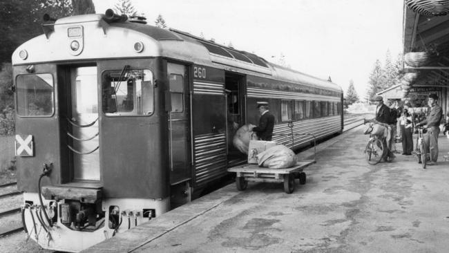 A Bluebird train is loaded with mail at the Victor Harbor railway station, 1983.