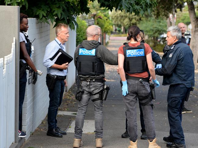 Police carry out the warrants in South Melbourne. Picture: Andrew Henshaw