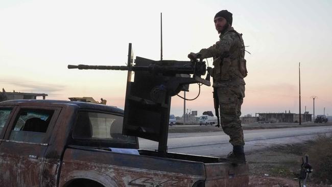 An anti-regime fighter mans a gun on a pick up on the Aleppo-Raqqa highway. Picture: Rami al Sayed/AFP