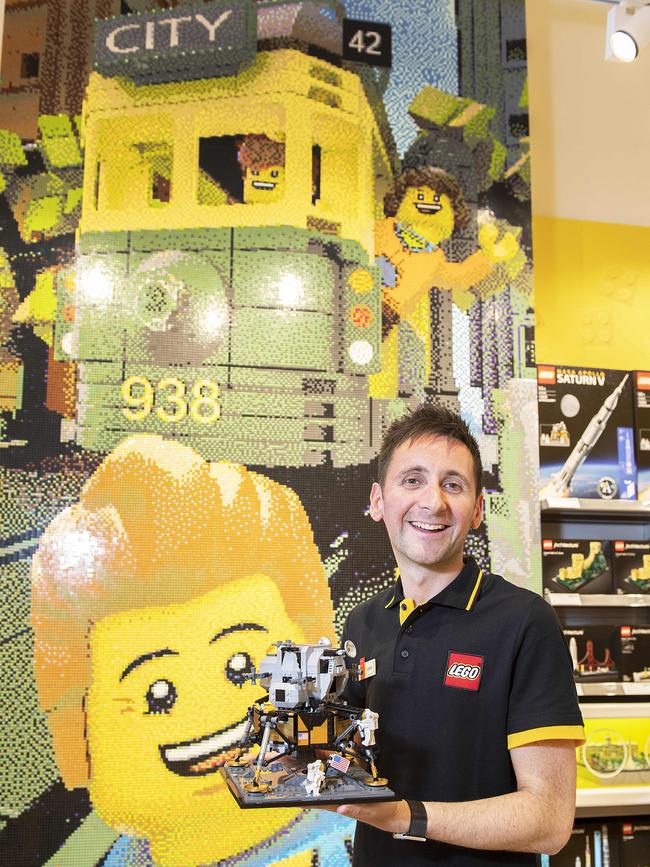 Store manager Chris Maclean in front of the Melbourne mosaic. Picture: Ellen Smith