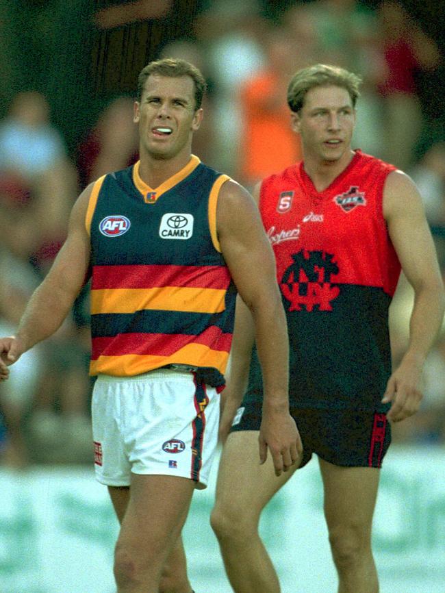 Carey with Stuart Bown during an AFL-SANFL charity match between the Crows and Norwood on The Parade, February 2003.