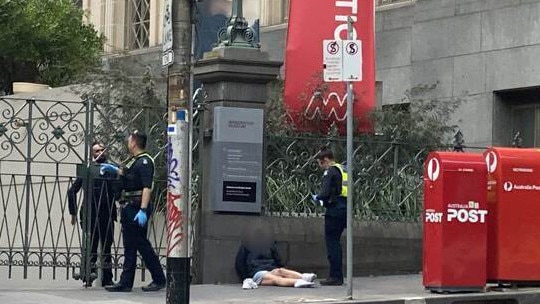 A woman slumped outside the Immigration Museum. Picture: Grace McKinnon