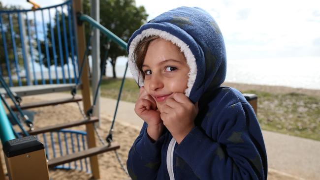 Bonny Blain, 4, of Trinity Park all rugged up while playing in the morning sun at Holloways Beach after a chilly Cairns morning. PICTURE: STEWART MCLEAN