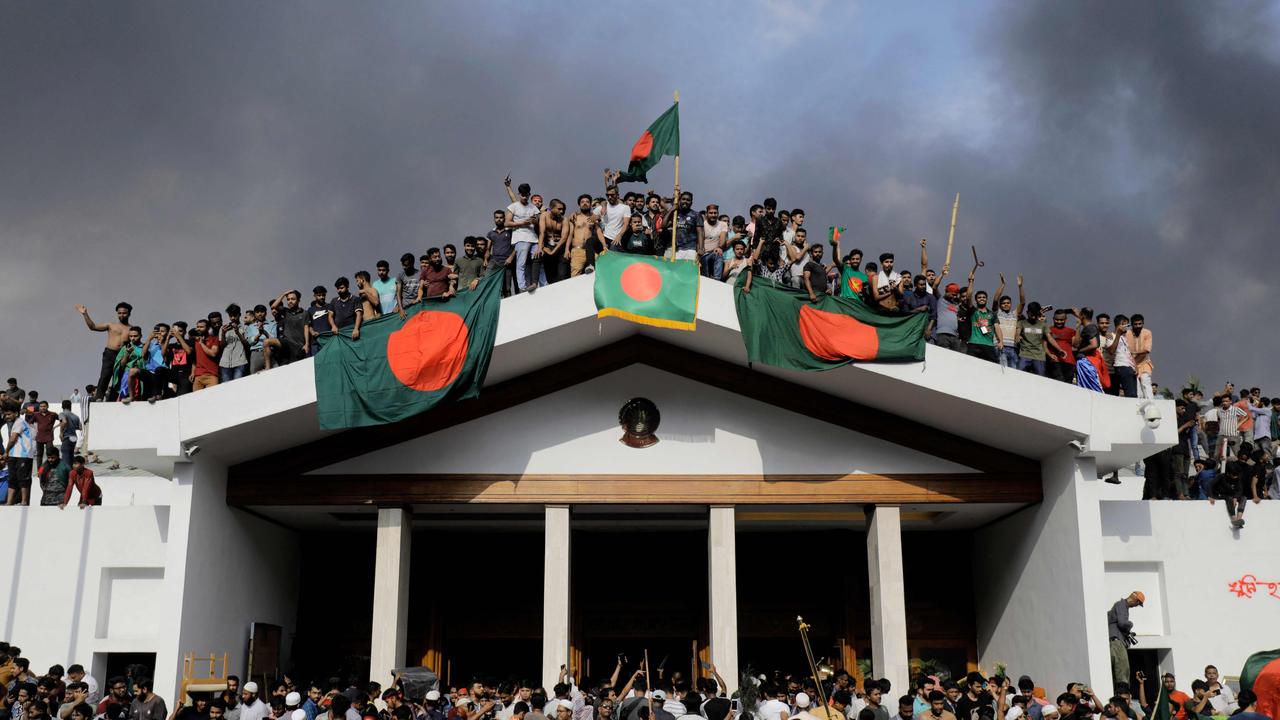 Anti-government protesters storm Prime Minister Sheikh Hasina’s palace in Dhaka. Picture: AFP