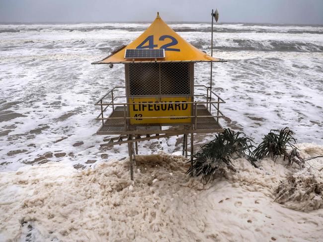 A tidal surge reaches the lifeguard tower at Main Beach on the Gold Coast. Picture: David Gray/AFP