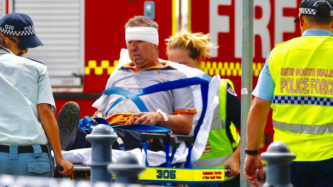 An injured crew member receives assistance after the Richmond derailment today. Picture: Dylan Robinson