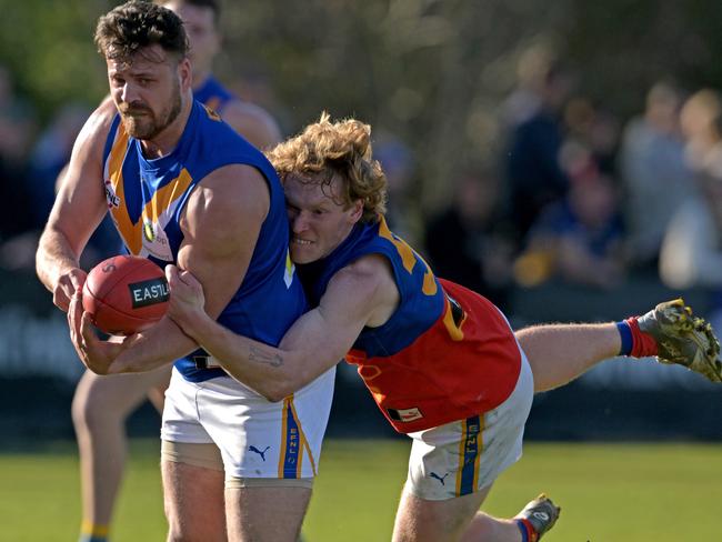 EFNL: Heathmont’s Campbell Evans is caught by Mulgrave’s James McGivern. Picture: Andy Brownbill