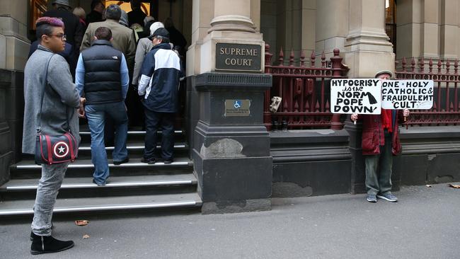 A protester stands outside the Supreme Court of Victoria. Picture: Getty Images