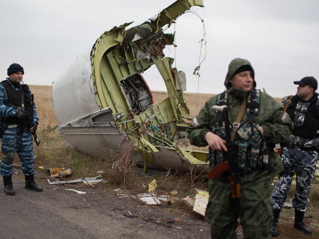 Pro-Russian gunmen stand guard as Dutch investigators (unseen) arrive near the Malaysia Airlines Flight MH17 crash site near Grabove village in eastern Ukraine in November 2014. Picture: Menahem Kahana / AFP