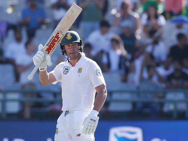 AB de Villiers raises his bat as he celebrates scoring a half-century against Australia.