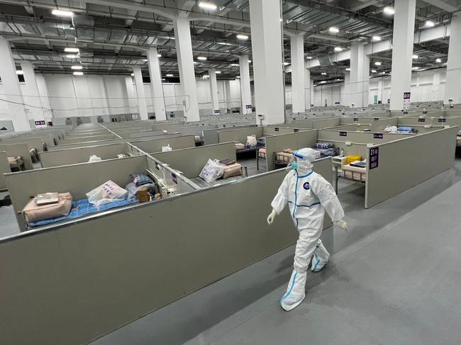 A staff member walks inside a makeshift hospital that will be used for coronavirus patients in Shanghai as the nation’s “zero Covid” policy drags on. Picture: AFP