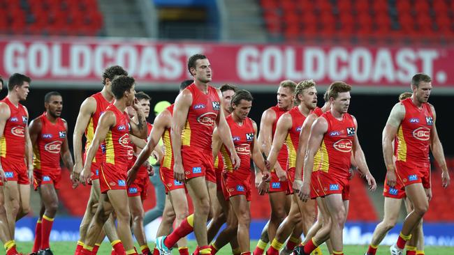 Jarrod Witts and the Suns leave the field during the round 1 AFL match between the Gold Coast Suns and the Port Adelaide Power at Metricon Stadium on March 21, 2020 in Gold Coast, Australia. (Photo by Chris Hyde/Getty Images)