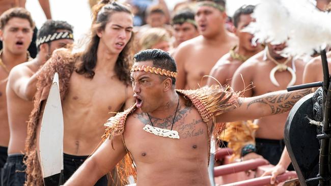 Traditional waka crews perform a haka on Te Tii beach after they paddled down the Waitangi River on Waitangi Day in Waitangi, New Zealand. Picture: AAP