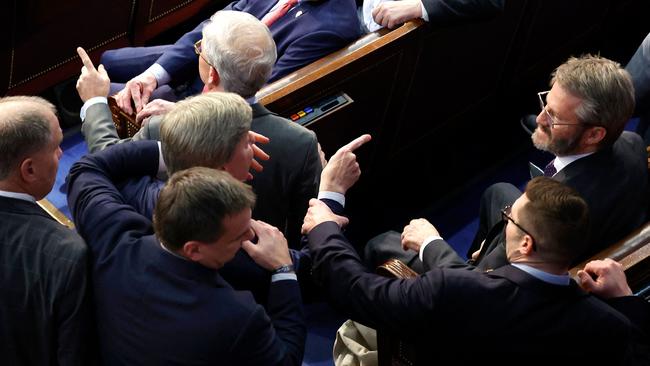 Mike Rogers is restrained after getting into an argument with Matt Gaetz. Pictures: Getty Images via AFP