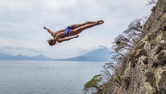 Rhiannan Iffland of Australia dives from the cliff at Bahia De Patzisotz with San Pedro volcano in the background during the Red Bull Cliff Diving World Series "Dive into Guatemala" at Lake Atitlan, Guatemala on April 20, 2023. // Dean Treml / Red Bull Content Pool // SI202305210363 // Usage for editorial use only //