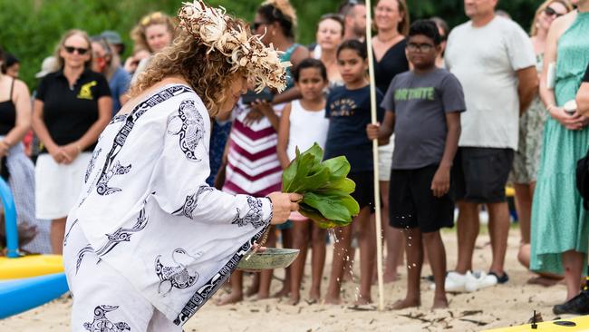 Maria Pokia applying a traditional Polynesian blessing to the newly acquired canoes on the Yorkeys Knob foreshore. Picture: Emily Barker