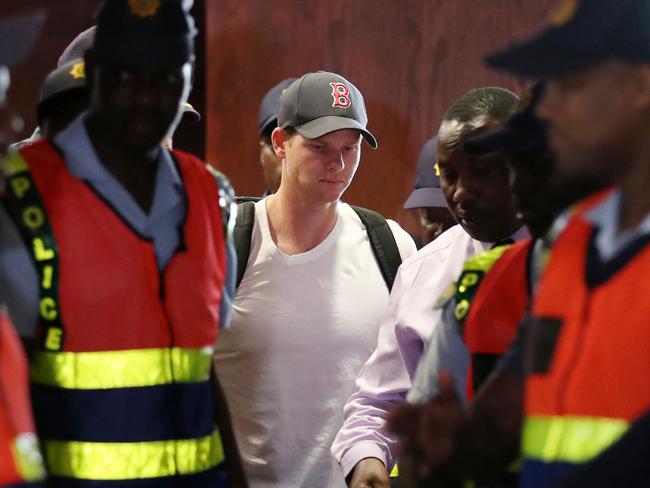 Former Australia captain Steve Smith looked broken as he was escorted through Tambo International airport by police officers. Photo: WP Media