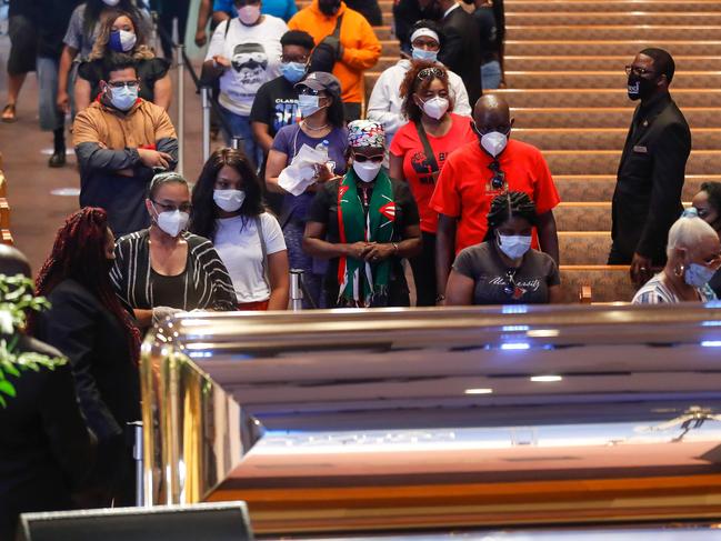 Mourners wait in line to pass by George Floyd’s golden casket. Picture: Godofredo A. Vasquez/AFP