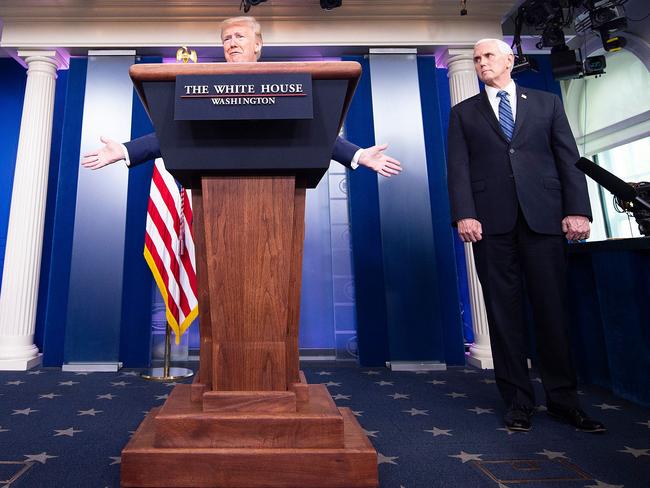 US President Donald Trump speaks as Vice President Mike Pence listens during the daily coronavirus briefing at the White House. Picture: AFP