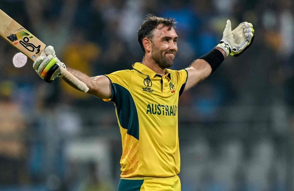 TOPSHOT - Australia's Glenn Maxwell celebrates after winning the 2023 ICC Men's Cricket World Cup one-day international (ODI) match between Australia and Afghanistan at the Wankhede Stadium in Mumbai on November 7, 2023. (Photo by INDRANIL MUKHERJEE / AFP) / -- IMAGE RESTRICTED TO EDITORIAL USE - STRICTLY NO COMMERCIAL USE --