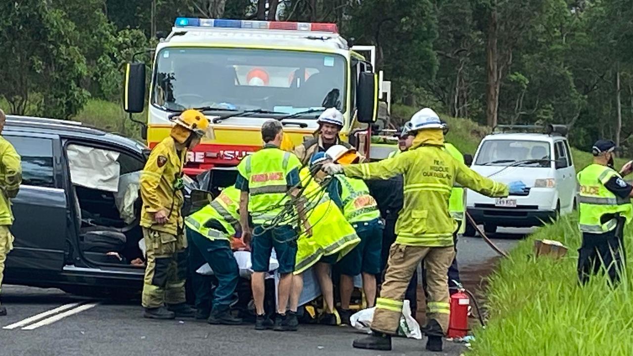 Paramedics treat a woman at the scene of the crash.