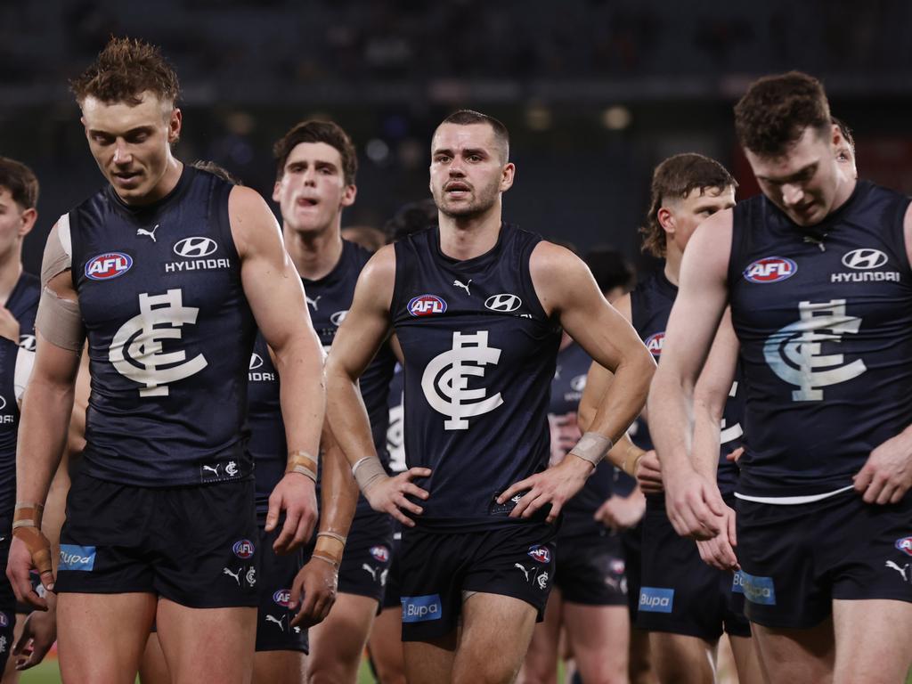 Disappointed Carlton players walk from the ground at Marvel Stadium. Picture: Darrian Traynor/Getty Images.