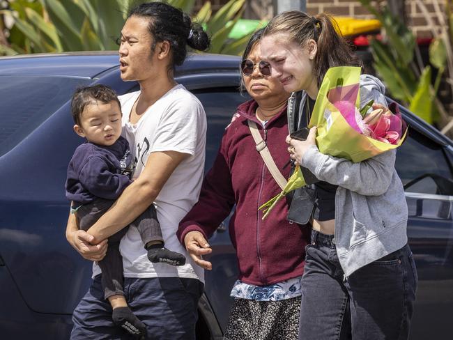 Distraught friends and relatives lay flowers at the scene. Picture: Jake Nowakowski