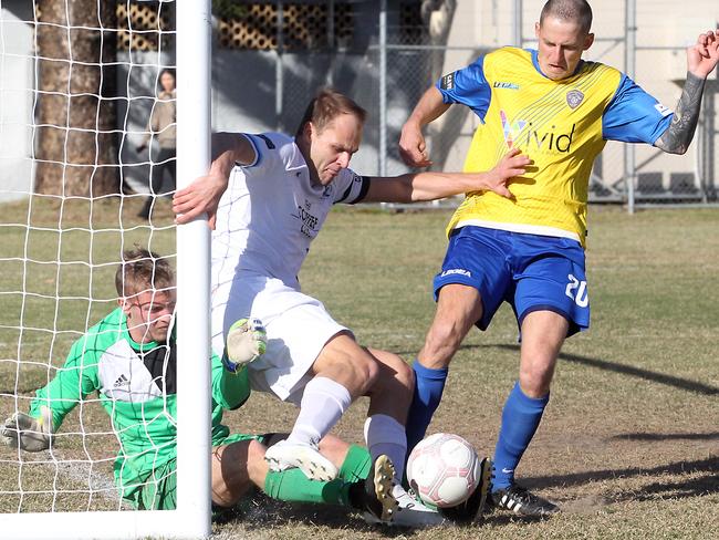 Teddy Watson (left) in action for Surfers Paradise against Broadbeach United last season. Picture: Richard Gosling