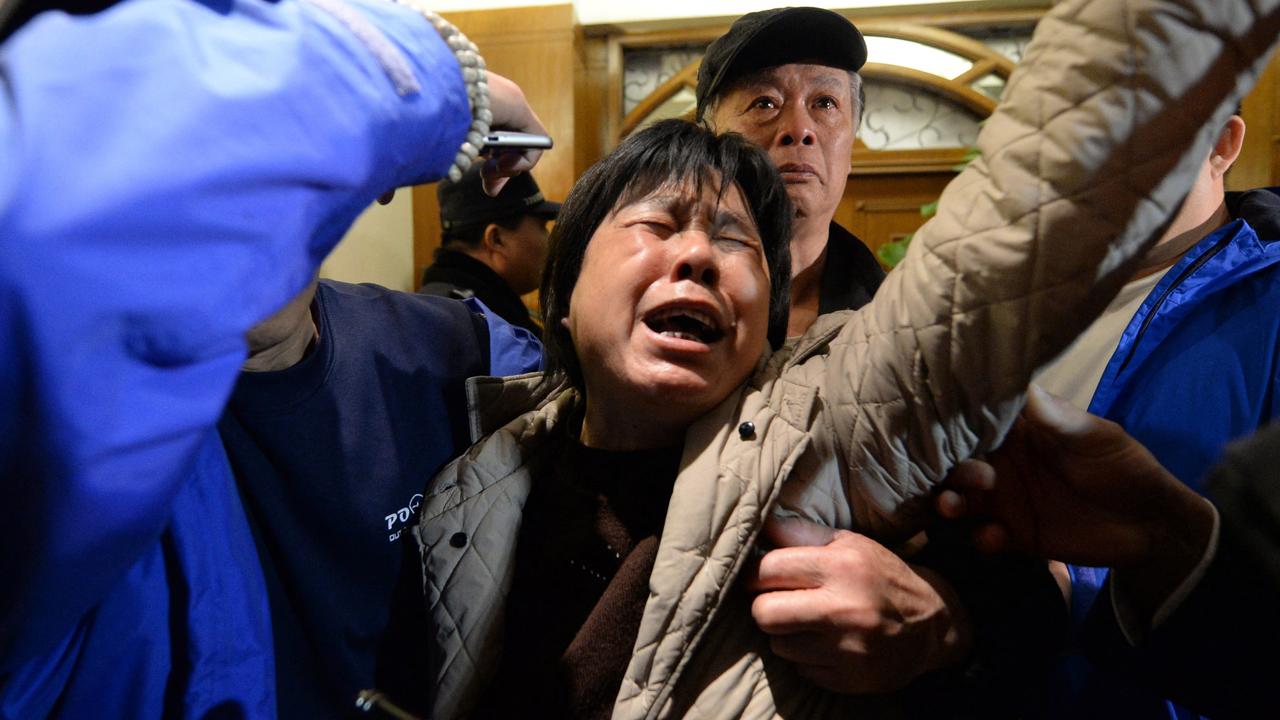 A relative of passengers on Malaysia Airlines flight MH370 cries after hearing the news that the plane plunged into Indian Ocean. Picture: Goh Chai Hin / AFP